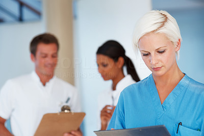 Pretty nurse reading a medical report