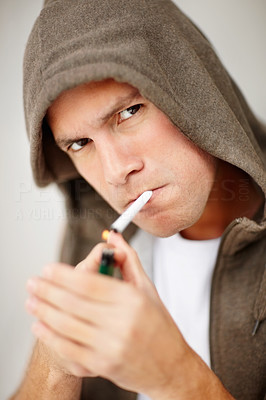 Closeup of a middle aged man lighting a cigarette