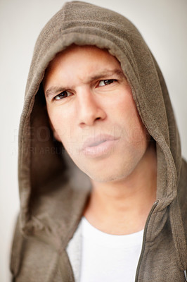 Middle aged man in a hood smoking a cigarette