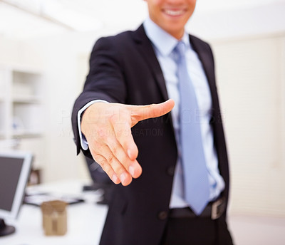 Mid section of confident business man with his hand stretched