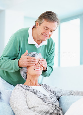 Retired old man covering a woman\'s eyes surprising her