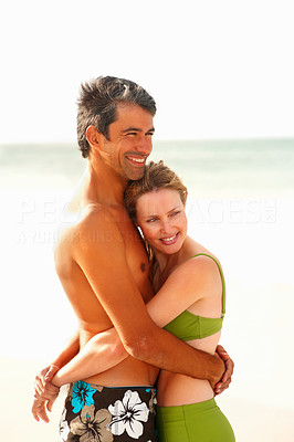Happy romantic couple hugging passionately while at the beach