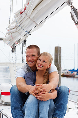 Voyage - Happy young couple sitting together on a boat