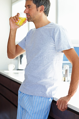 Thoughtful man drinking orange juice