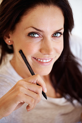 Happy woman holding pen