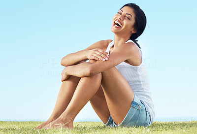 Young lady sitting on the grass - Enjoying summer