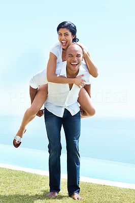Young man giving piggy back ride to his girlfriend