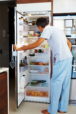 Hunger: Mature man opening the refrigerator door