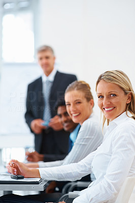 A lovely business woman smiling along with her office staff