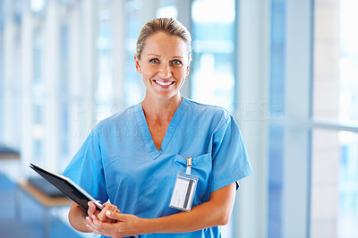 An attractive young nurse holding a clipboard