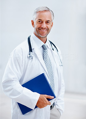 Handsome senior doctor holding a file