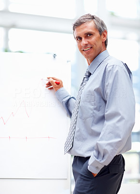 Confident business man explaining with the help of a white board