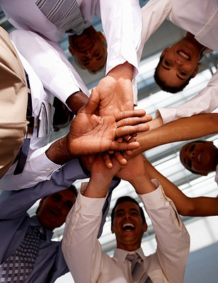 Upward view: Business people with hands together
