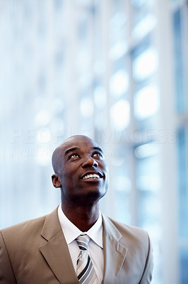 An African American business man looking upwards