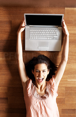 Excited young woman holding her new laptop