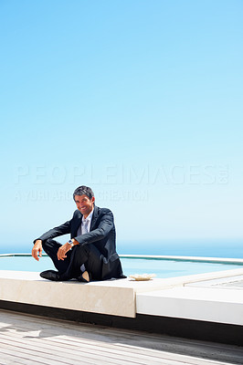 Portrait of a relaxed business man against the blue sky