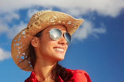 Trendy young woman over the blue sky background