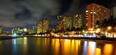 A nigh photo of Waikiki hotels and beach skylines