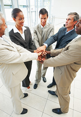 Group of successful business people with their hands joined together