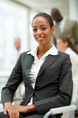 A satisfied African American business woman sitting in the office