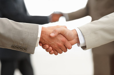 Closeup of business men shaking hands at the workplace