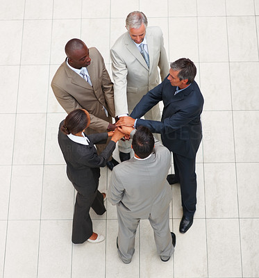 Top view of business people with their hands together in unity
