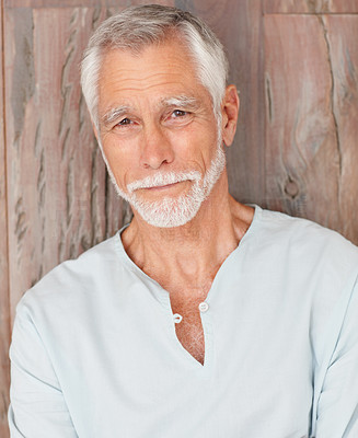 Happy old man over a wooden background