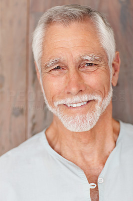 Happy senior man, smiling over a wooden background