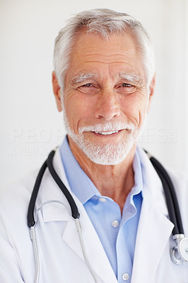Closeup of a senior mature doctor isolated over grey background