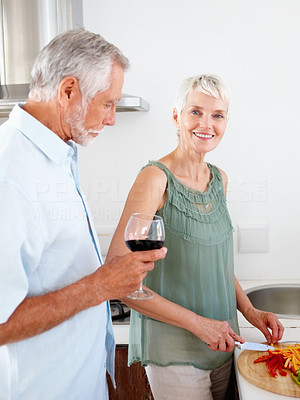 Senior couple preparing food in the kitchen
