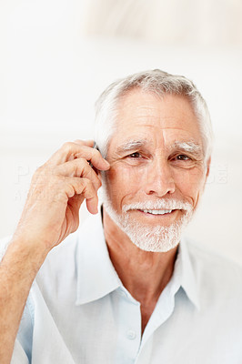 A smart old man communicating using cellular phone