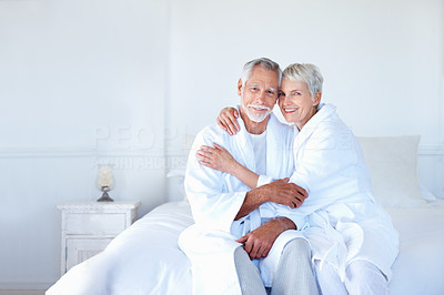 An old couple having fun together in the bedroom