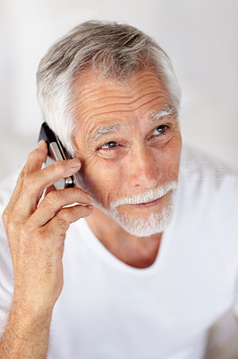 An old happy man speaking on a mobile
