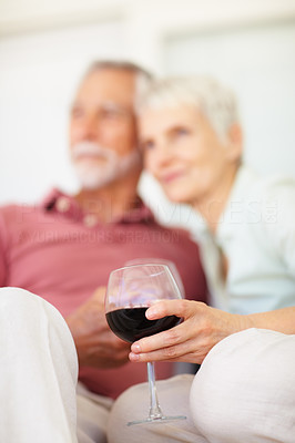 Blur image of an elderly couple holding a wine glass