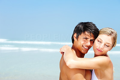 Couple hugging each other and romancing at the sea shore