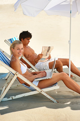 Attractive couple relaxing on a deck chair at summer vacation