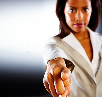 Blur image of an African American business woman in anger over dark background
