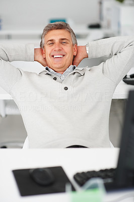 Happy mature business man relaxing on a office desk