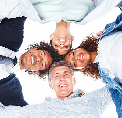 Upward view of happy business people with their heads together on a white background