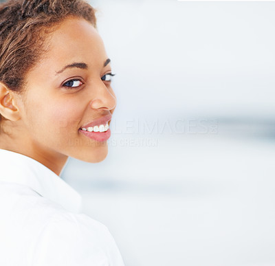 Closeup portrait of a beautiful young lady smiling over a background
