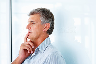 Closeup of a mature man looking away and thinking