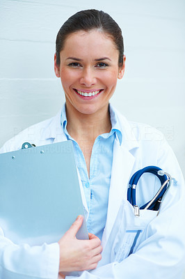 Portrait of happy young lady doctor over white background