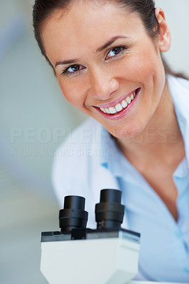 Closeup of medical doctor working with a microscope