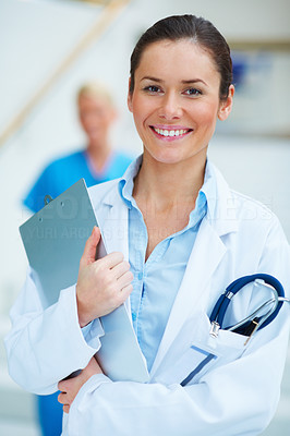 Smiling medical doctor with stethoscope and clipboard
