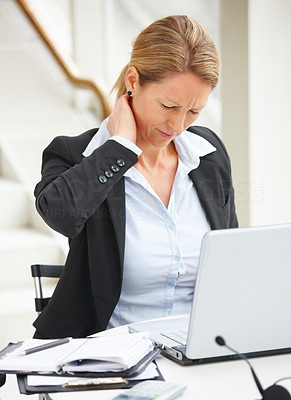 Business woman suffering from pain while sitting in the office