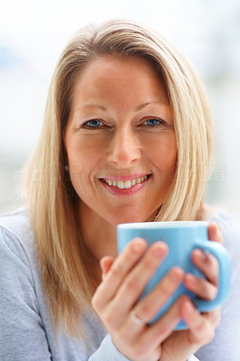 Closeup portrait of a happy woman holding a coffee cup