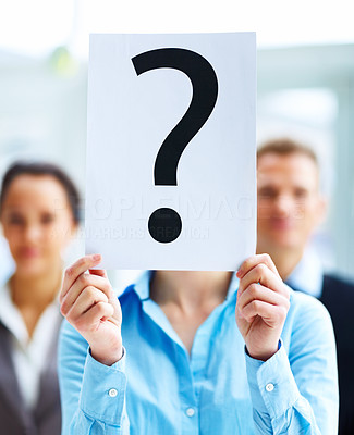 Closeup of businesspeople holding question mark on boards