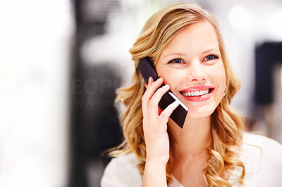 Closeup of a happy young woman speaking on a mobile phone