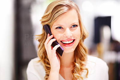 Closeup of a beautiful young woman speaking on a mobile phone