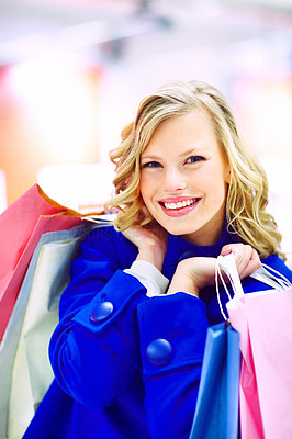 An excited pretty woman holding many shopping bags